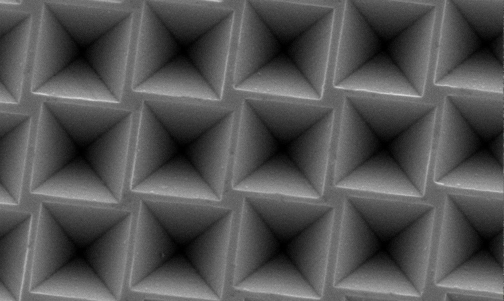 SEM image of a regular array of square inverted pyramids for a chiral plasmonic metasurface.